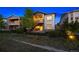 Charming townhome with stone accents, a private patio, and well-maintained landscaping under a night sky at 22978 E Bailey Cir, Aurora, CO 80016