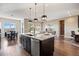 Open-concept kitchen with granite countertops, a large island, and seamless flow into the dining and living areas at 22978 E Bailey Cir, Aurora, CO 80016