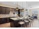 Elegant kitchen with a granite island, stainless steel appliances, and seamless integration into the dining area at 22978 E Bailey Cir, Aurora, CO 80016