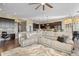 Cozy living area with sectional sofa, neutral palette, and open flow to kitchen with granite counters at 22978 E Bailey Cir, Aurora, CO 80016