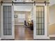 Bright home office space with wood floors, stylish barn doors, and large windows at 22978 E Bailey Cir, Aurora, CO 80016