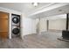 Finished basement area complete with washer/dryer, adjacent to a wood-burning stove at 8401 Sandreed Cir, Parker, CO 80134