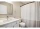 Bathroom featuring a bright white vanity, commode, and shower with matching white shower curtain at 8401 Sandreed Cir, Parker, CO 80134
