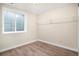 Bedroom with wood-look flooring, a security window and closet rod at 8401 Sandreed Cir, Parker, CO 80134