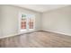 Bedroom with light walls, wood-look flooring, and a French doors leading to outdoor space at 8401 Sandreed Cir, Parker, CO 80134