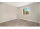 Bright bedroom with wood-look flooring, a large window, and fresh neutral paint at 8401 Sandreed Cir, Parker, CO 80134