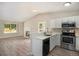 Bright kitchen with modern appliances, countertop dining and view into the adjacent living room at 8401 Sandreed Cir, Parker, CO 80134
