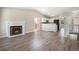 Open-concept living room with fireplace and adjacent kitchen with stainless steel appliances at 8401 Sandreed Cir, Parker, CO 80134