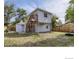 Expansive backyard featuring a two-story home, garage, and a mix of grass and natural landscape at 11502 E 7Th E Ave, Aurora, CO 80010