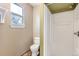 Cozy bathroom featuring a toilet and shower with tiled floors and a window at 11502 E 7Th E Ave, Aurora, CO 80010