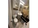 Bathroom featuring a shower with gold trim, toilet, vanity, and mirrored cabinet at 11502 E 7Th E Ave, Aurora, CO 80010