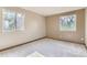 Bright bedroom with carpeted floors and natural light streaming through multiple windows at 11502 E 7Th E Ave, Aurora, CO 80010