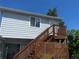 House featuring elevated porch with wood stairs, a satellite dish and an outdoor sitting area below at 11502 E 7Th E Ave, Aurora, CO 80010