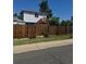 Charming house featuring a fenced backyard and an elevated porch with stairs at 11502 E 7Th E Ave, Aurora, CO 80010