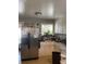 Functional kitchen with a stainless steel refrigerator and white cabinets at 11502 E 7Th E Ave, Aurora, CO 80010