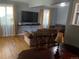 Cozy living room featuring hardwood floors, comfortable seating, and a large wall-mounted TV at 11502 E 7Th E Ave, Aurora, CO 80010