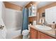Cozy bathroom featuring a combination tub and shower, single vanity, and neutral decor at 16863 Trail View Cir, Parker, CO 80134