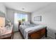 Cozy bedroom featuring a wood frame bed with blue bedding and a bright window view at 16863 Trail View Cir, Parker, CO 80134