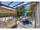 Inviting covered patio featuring a grill, dining table, and decorative lattice, creating a relaxed outdoor living space at 16863 Trail View Cir, Parker, CO 80134