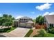 Beautiful two-story home featuring manicured lawn and a three-car garage at 16863 Trail View Cir, Parker, CO 80134