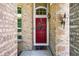 Inviting front entrance with a red door, brick surround, and a welcoming 'hello' doormat at 16863 Trail View Cir, Parker, CO 80134