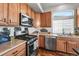 Well-equipped kitchen with stainless steel appliances, light wood cabinetry, and a bright, sunny window at 16863 Trail View Cir, Parker, CO 80134