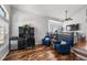 Stylish living room featuring hardwood floors, comfortable seating, and a functional home office setup at 16863 Trail View Cir, Parker, CO 80134