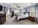 Spacious main bedroom featuring a sitting area, bay window, ceiling fan, and ensuite bathroom at 16863 Trail View Cir, Parker, CO 80134