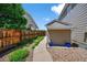 Side yard featuring a storage shed, gravel landscaping, and a wooden fence providing privacy at 16863 Trail View Cir, Parker, CO 80134