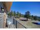 Relax on the balcony with picturesque views of the lush, tree-filled landscape and clear blue sky at 6300 Summer Star Ln, Golden, CO 80403