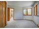 Spacious bedroom with ample light with wood trim and multiple windows showcasing scenic outdoor views at 6300 Summer Star Ln, Golden, CO 80403