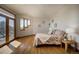 Bright bedroom with hardwood floors, natural light, a walkout balcony, and calming decor at 6300 Summer Star Ln, Golden, CO 80403