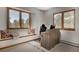 Comfortable bedroom with large windows, window seat, and dedicated desk space for work or study at 6300 Summer Star Ln, Golden, CO 80403