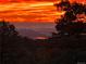 Panoramic cityscape view at sunset from atop the mountain treeline at 6300 Summer Star Ln, Golden, CO 80403