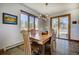 Bright dining room featuring natural wood table and chairs with a decorative chandelier at 6300 Summer Star Ln, Golden, CO 80403