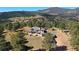 A captivating home with an incredible mountain view and mature trees on sprawling acreage at 6300 Summer Star Ln, Golden, CO 80403