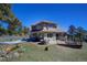 View of the home's exterior featuring a patio, seating area, and hot tub at 6300 Summer Star Ln, Golden, CO 80403