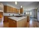 Open kitchen boasts ample cabinet space, an island cooktop, and seamless flow into the dining area at 6300 Summer Star Ln, Golden, CO 80403
