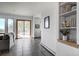 Open concept living room featuring slate floors, a wall shelf, and large sliding glass doors to patio at 6300 Summer Star Ln, Golden, CO 80403