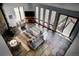 Spacious living room with fireplace, large windows, stone floors, and access to a deck at 6300 Summer Star Ln, Golden, CO 80403
