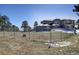 Spacious fenced yard with views of the home and mature landscaping at 6300 Summer Star Ln, Golden, CO 80403