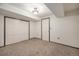 Unfinished basement space has neutral carpet and a storage closet at 13486 Clayton St, Thornton, CO 80241