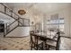 Bright dining area with high ceilings, large windows, and stylish lighting at 13486 Clayton St, Thornton, CO 80241