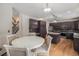 Bright kitchen with a white table, wood floors, stainless steel appliances and dark brown cabinetry at 13486 Clayton St, Thornton, CO 80241