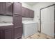 Laundry room with matching washer and dryer, built-in cabinets, and a tiled floor at 13486 Clayton St, Thornton, CO 80241