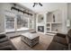 Living room with a fireplace, decorative shelving, a large window view, and comfortable seating at 13486 Clayton St, Thornton, CO 80241