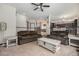 Comfortable living room with neutral carpet, a staircase view, and access to the dining and kitchen areas at 13486 Clayton St, Thornton, CO 80241