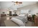 This spacious bedroom offers ample natural light, wood floors, a ceiling fan and an attached sitting room at 13486 Clayton St, Thornton, CO 80241