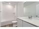 Modern bathroom with white tile, sleek fixtures, and a bathtub-shower combination at 22036 E 39Th Pl, Aurora, CO 80019