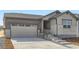 Inviting home with a two-car garage, stone details, and a welcoming entrance at 22036 E 39Th Pl, Aurora, CO 80019
